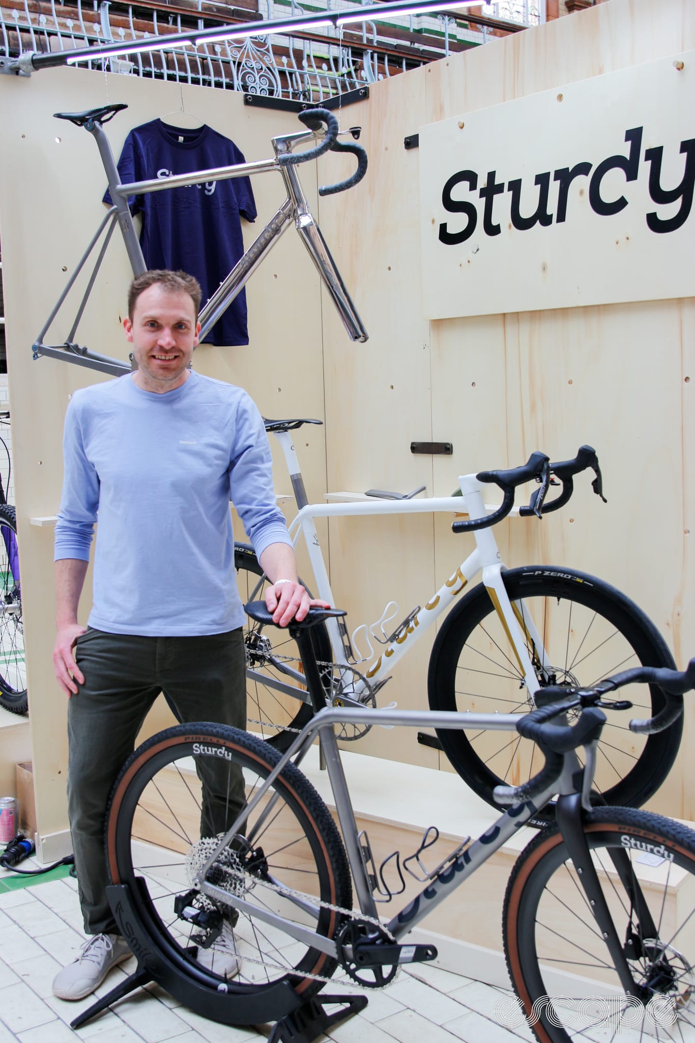 Tom Sturdy, founder and ownder of Sturdy cycles, standing at the stand with his bikes